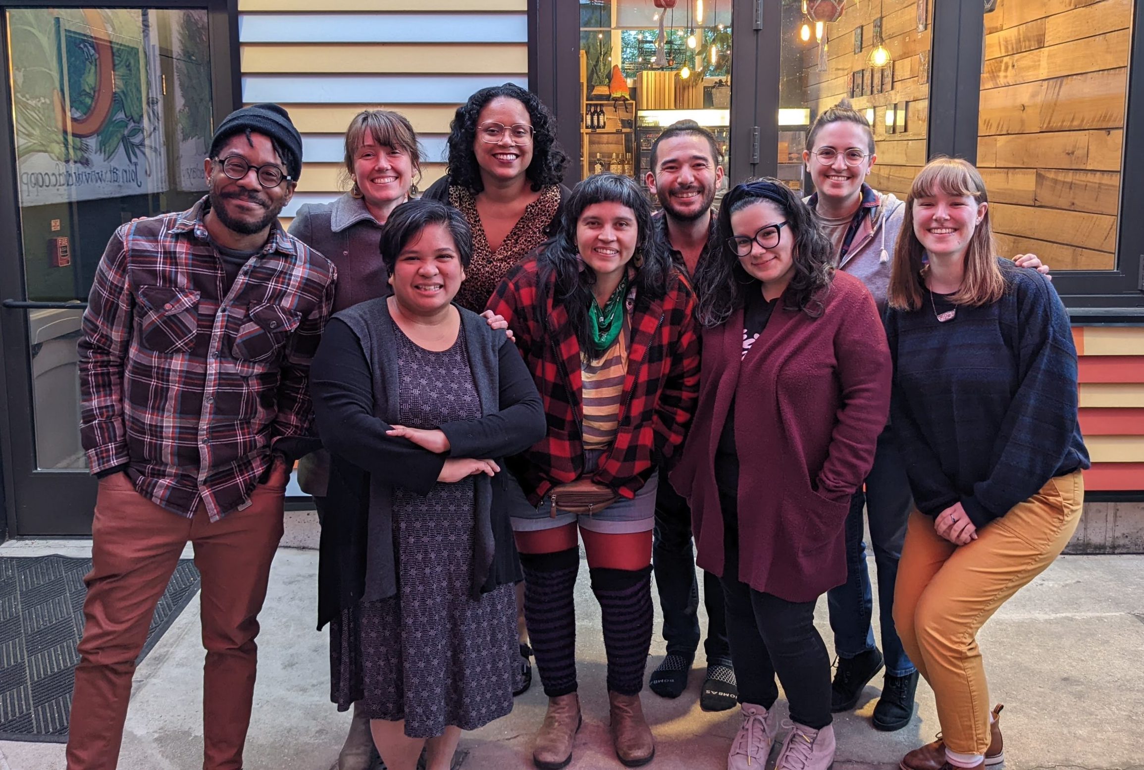 Group photo of departing staff members Gabrielle Chapman, Ana Martina Rivas, and Daniel Park, surrounded by fellow staff members.