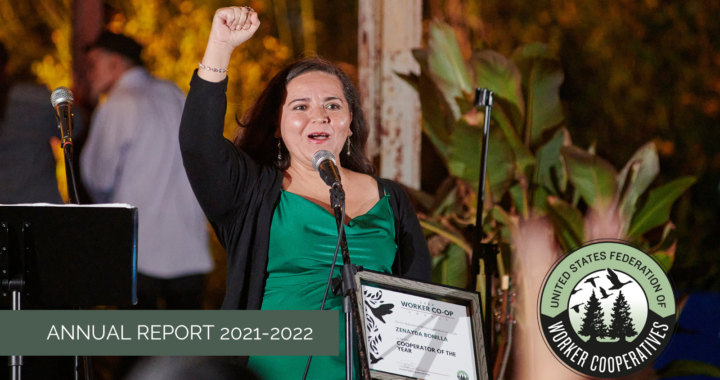 A photo of a woman with light skin, dark hair, wearing a black cardigan over a green gown, with a fist held high and holding a plaque that reads Zenayda Bonilla, worker cooperator of the year. Below the photo of Zenayda is the text Annual Report 2021-2022 and the logo of the USFWC.