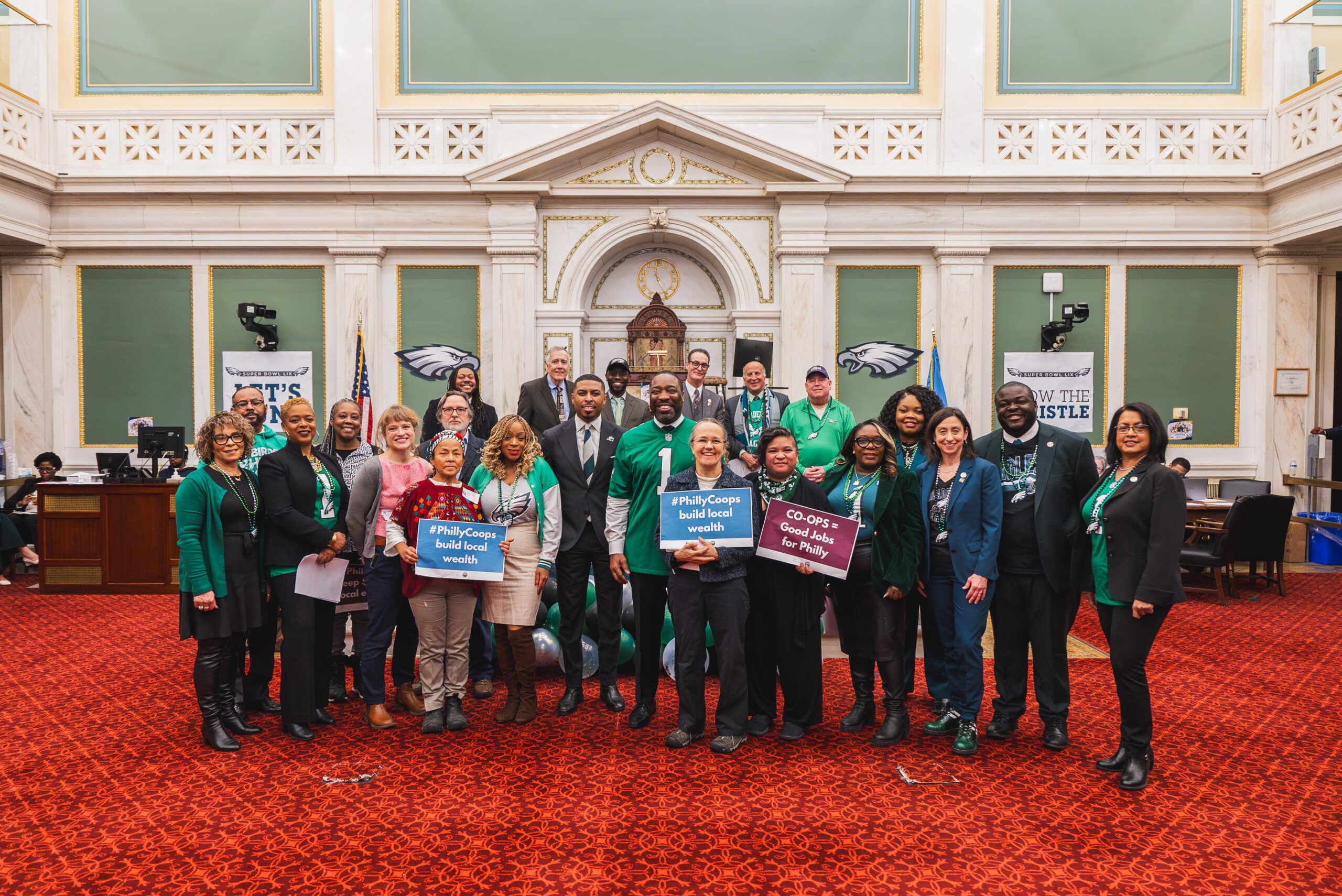 Philadelphia City Council members, worker-owners and advocates pose after city passes resolution declaring 2025 the Year of Cooperatives