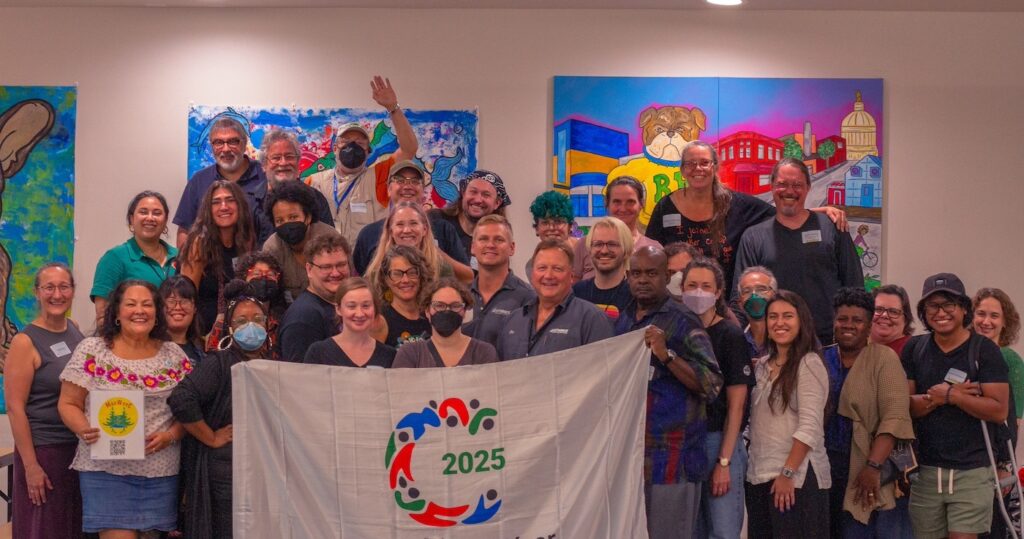 A group of Regional Rendezvous participants holding the UN International Year of Cooperatives flag