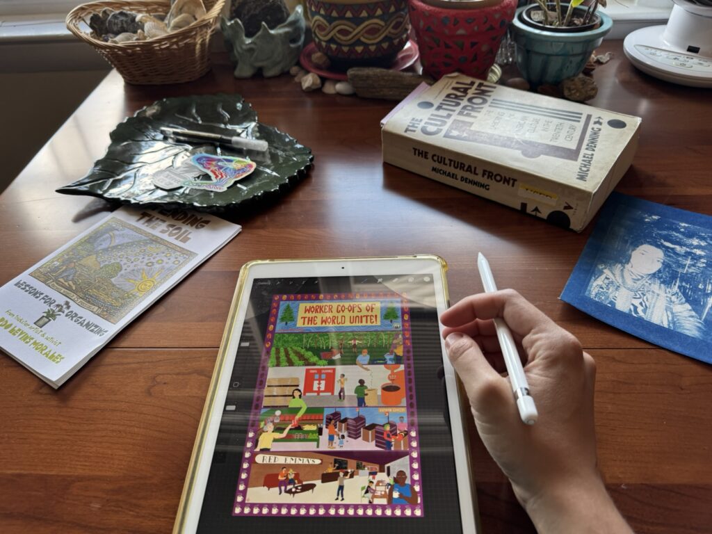 Desk with e-tablet and pen surrounded by terracotta pots, a book that says "the cultural front" and a pamphlet that says "lessons for organizing" 