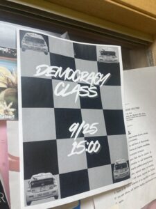 photo of a flyer on a wall with text that reads democracy class 