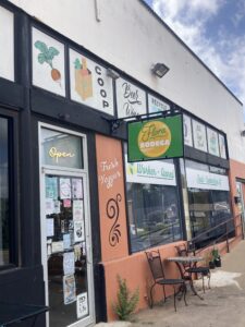 a storefront with a sign that reads flora bodega